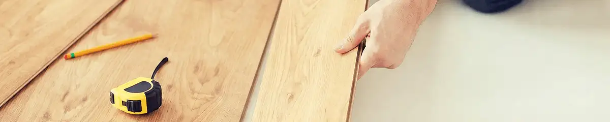 A professional installing wood flooring in Providence, RI