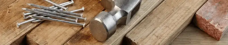 Hammer and nails on hardwood flooring boards in Providence, RI
