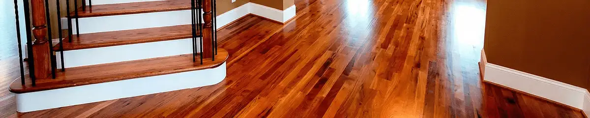 Base floor of a staircase with professionally restored wood flooring in Providence RI