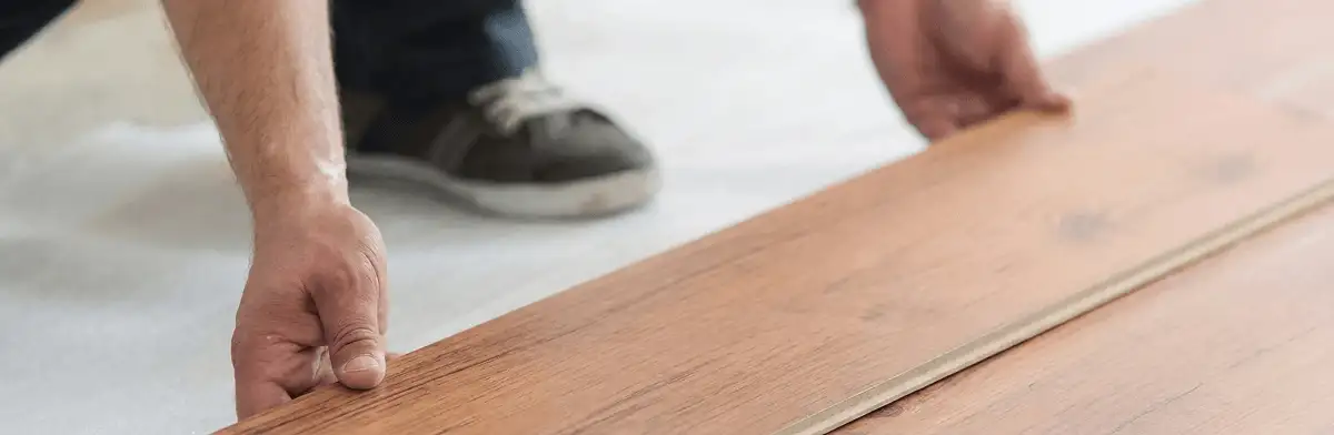 A professional installing laminate flooring in Providence, RI