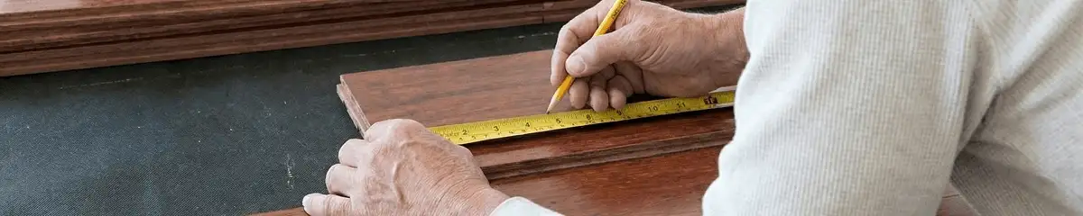 A professional installing wood flooring in Providence, RI